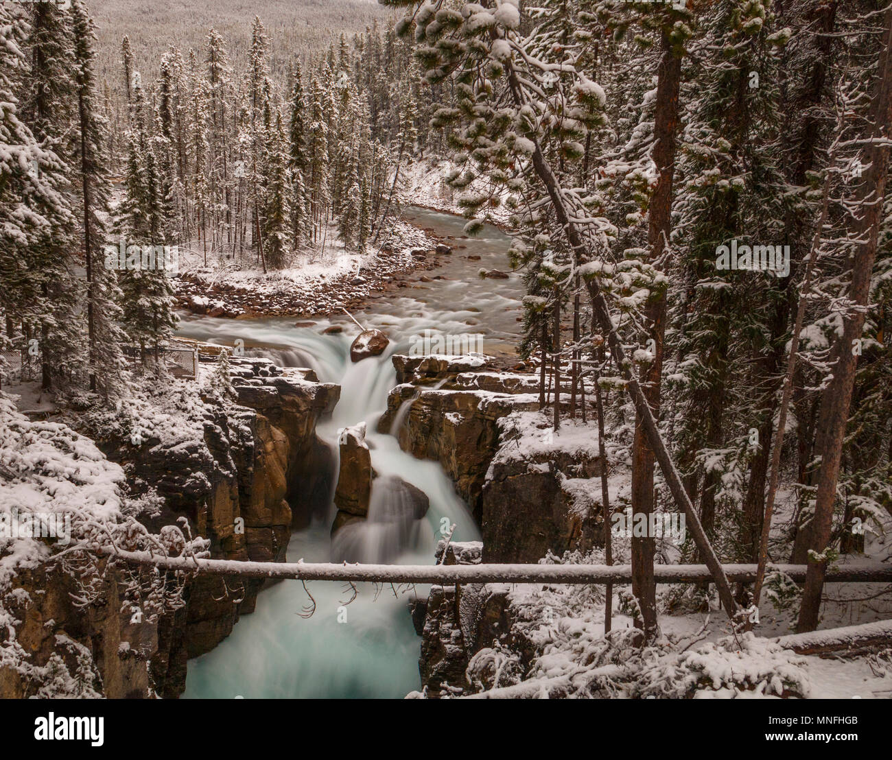 Sunwapta falls in Jasper National Park in October with fresh snow, beautiful long exposure using ND filter giving a creamy look to the water. Stock Photo