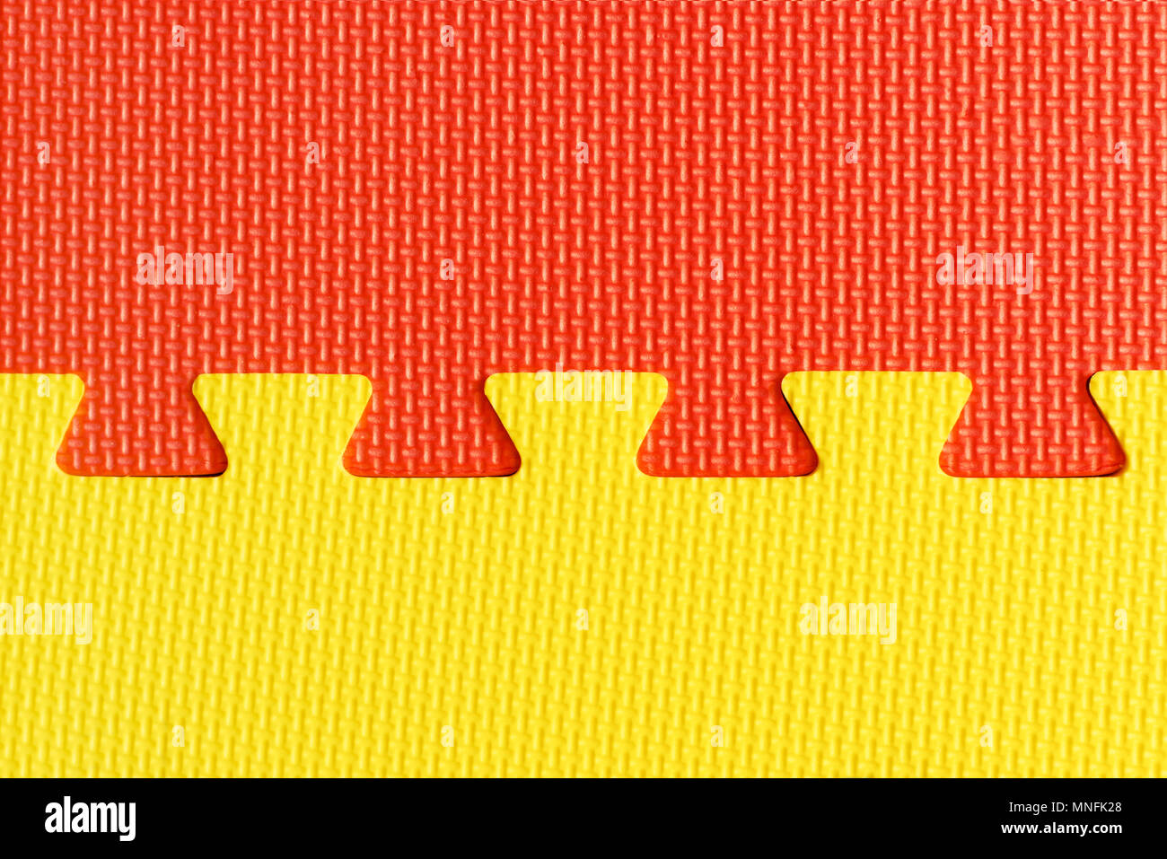 Red and yellow interlocking rubber foam flooring for babies and