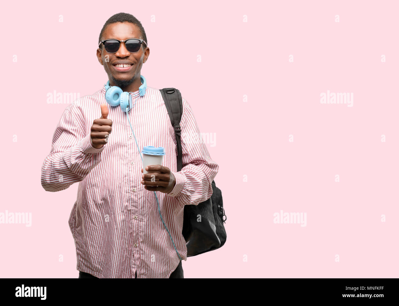 African black man student smiling broadly showing thumbs up gesture to ...