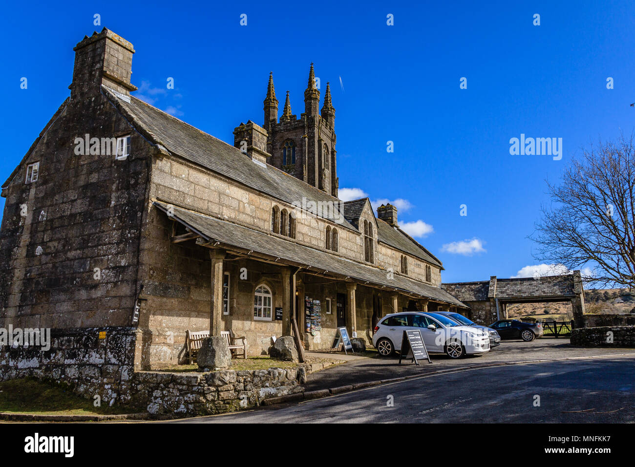 Street view of the Church House and church on a sunny day, Widecombe in the Moor, Dartmoor, Devon. March 2018. Stock Photo