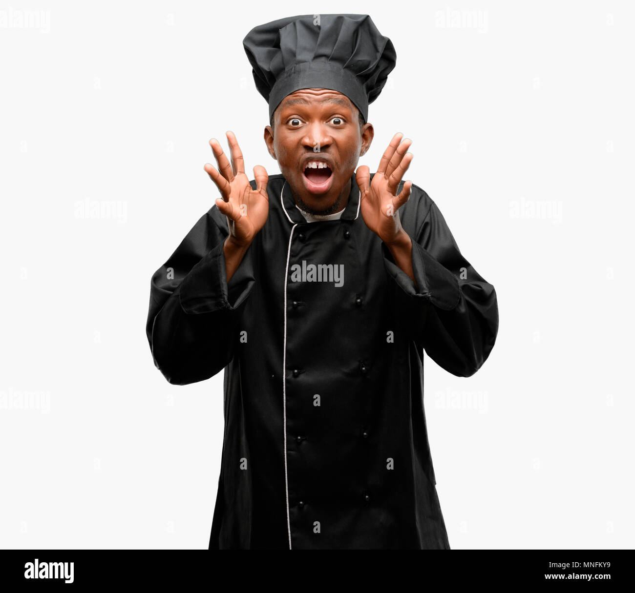 Young black cook wearing chef hat stressful keeping hands on head ...