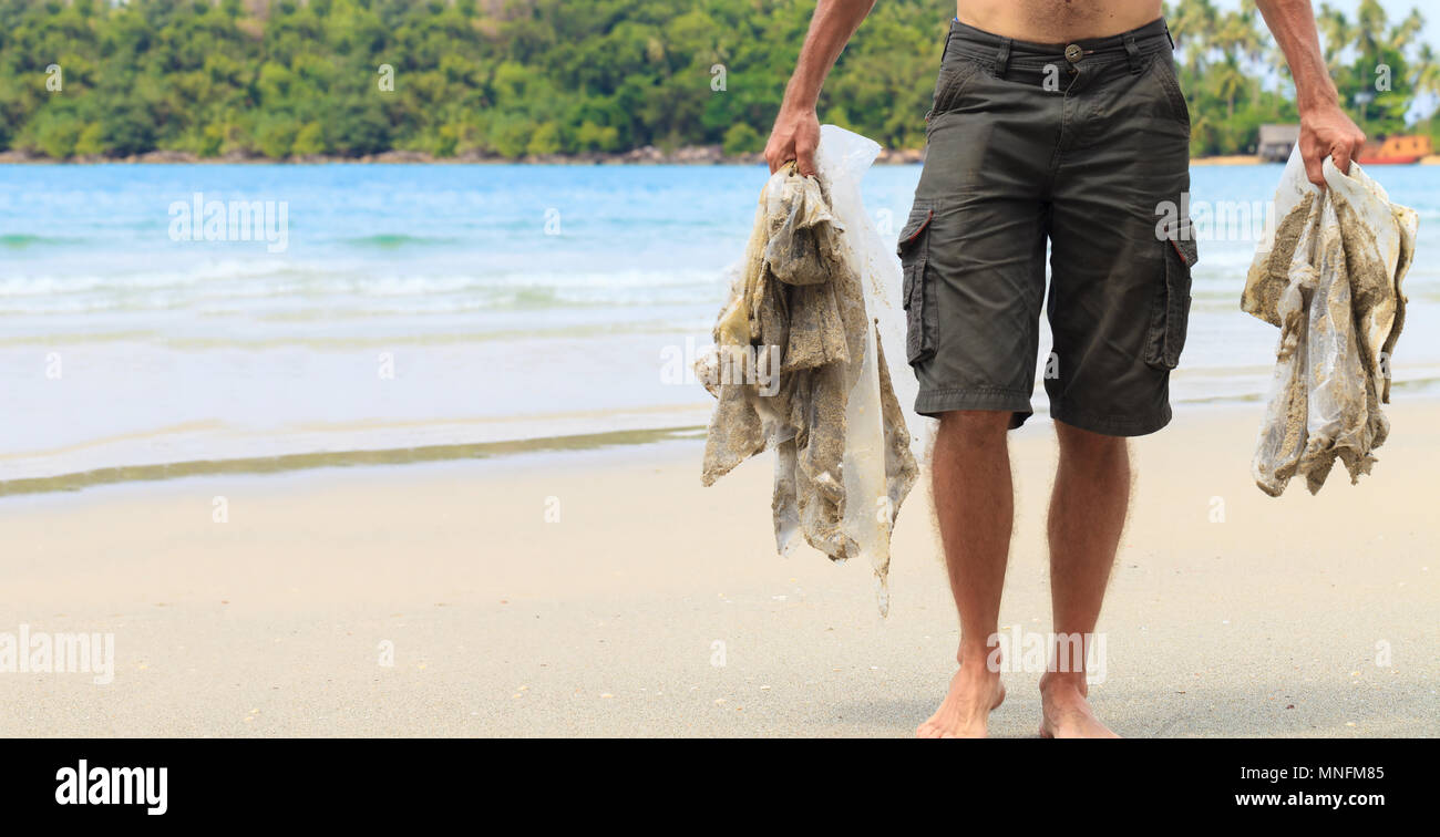People clean beach from plastic debris. Concept save planet and nature Stock Photo