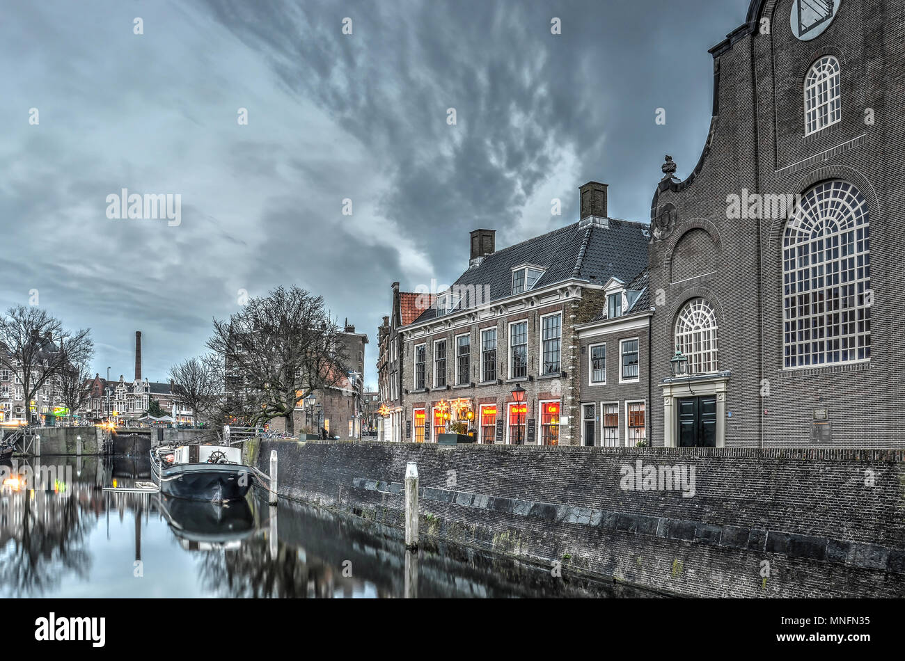 Rotterdam, The Netherlands, December 19, 2015: Early evening at Aelbrechtskolk canal in Delfshaven with the Pilgrimfathers Church and the Pelgrim brew Stock Photo