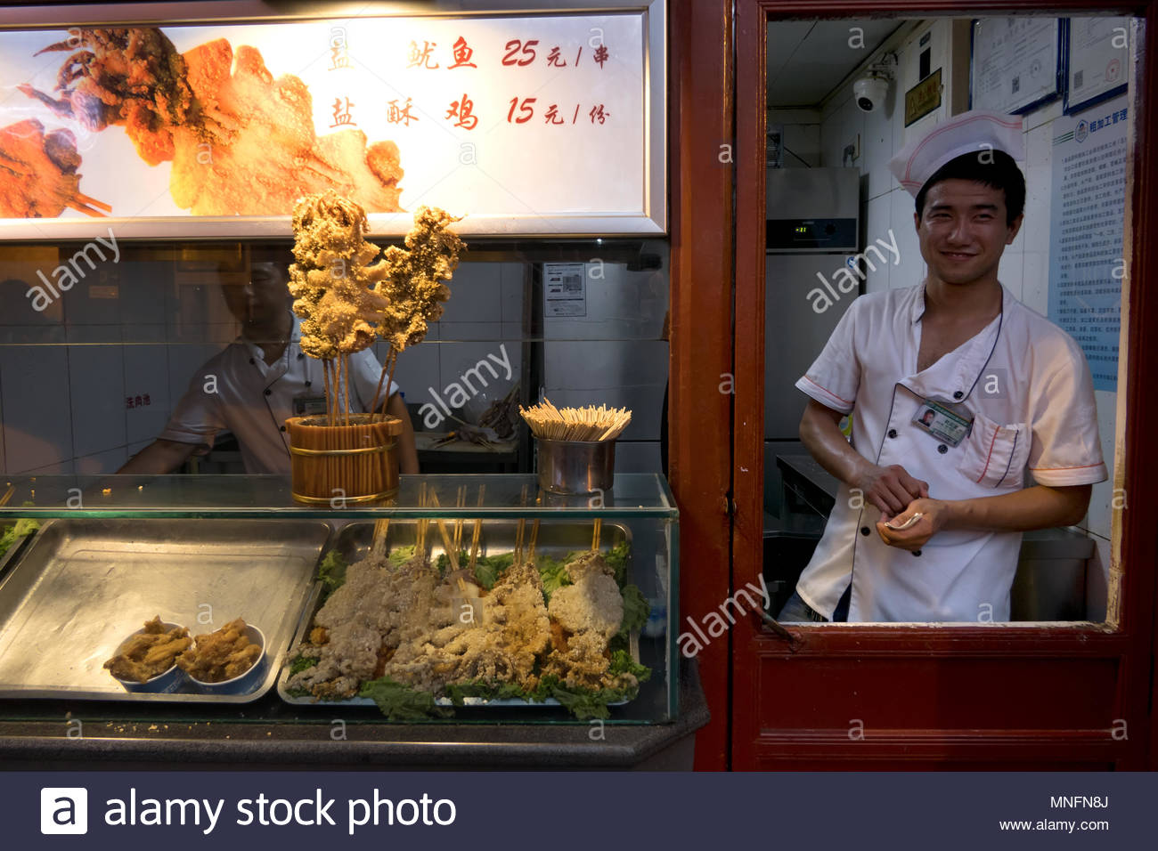 Chinese Cook Working In Asian Restaurant Kitchen In Beijing China