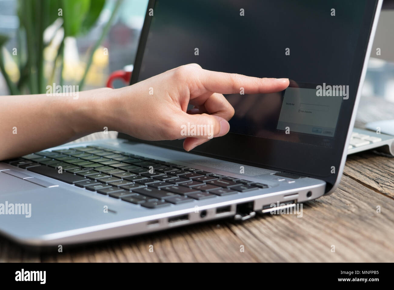 Focus on the point figer touching the laptop screen for inputing the