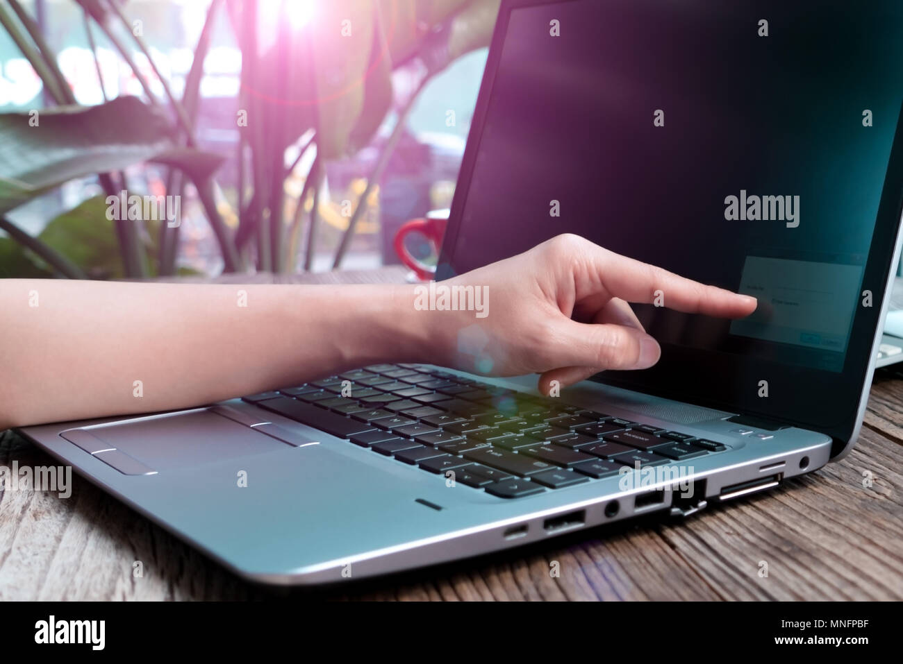 The point figer touching the laptop screen for inputing the network