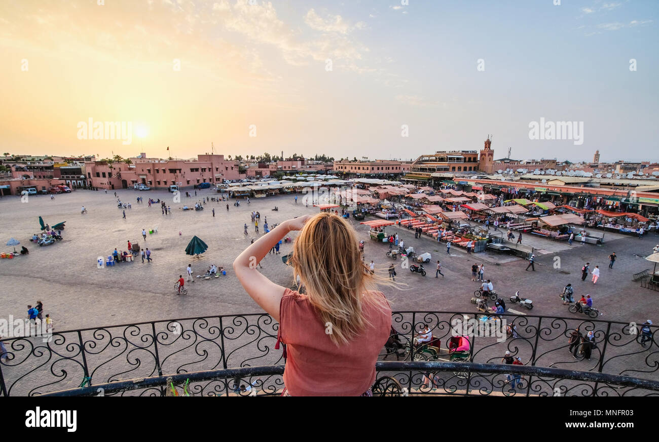 Tourist watching over Jamaa el-Fna Market Marrakesh - Morocco. Sunset view. Stock Photo