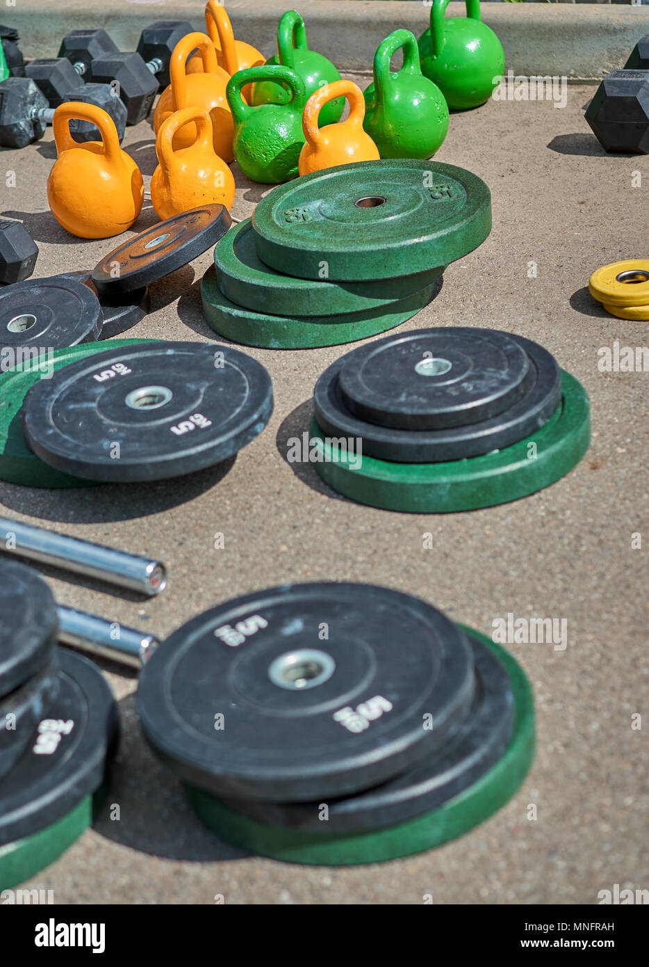 athlete near the barbell on the street Stock Photo Alamy