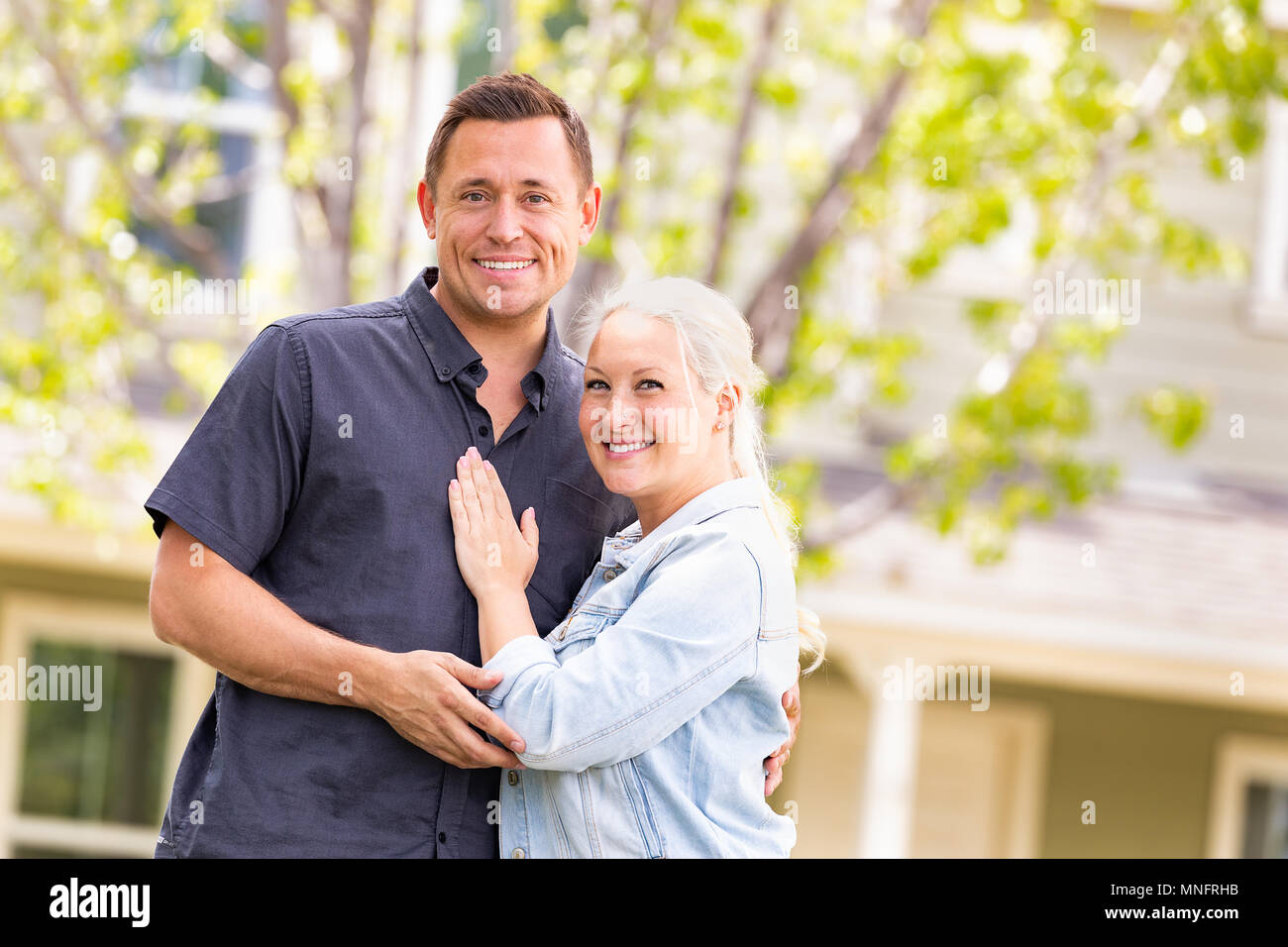 Happy caucasian couple in front of house stock photo alamy