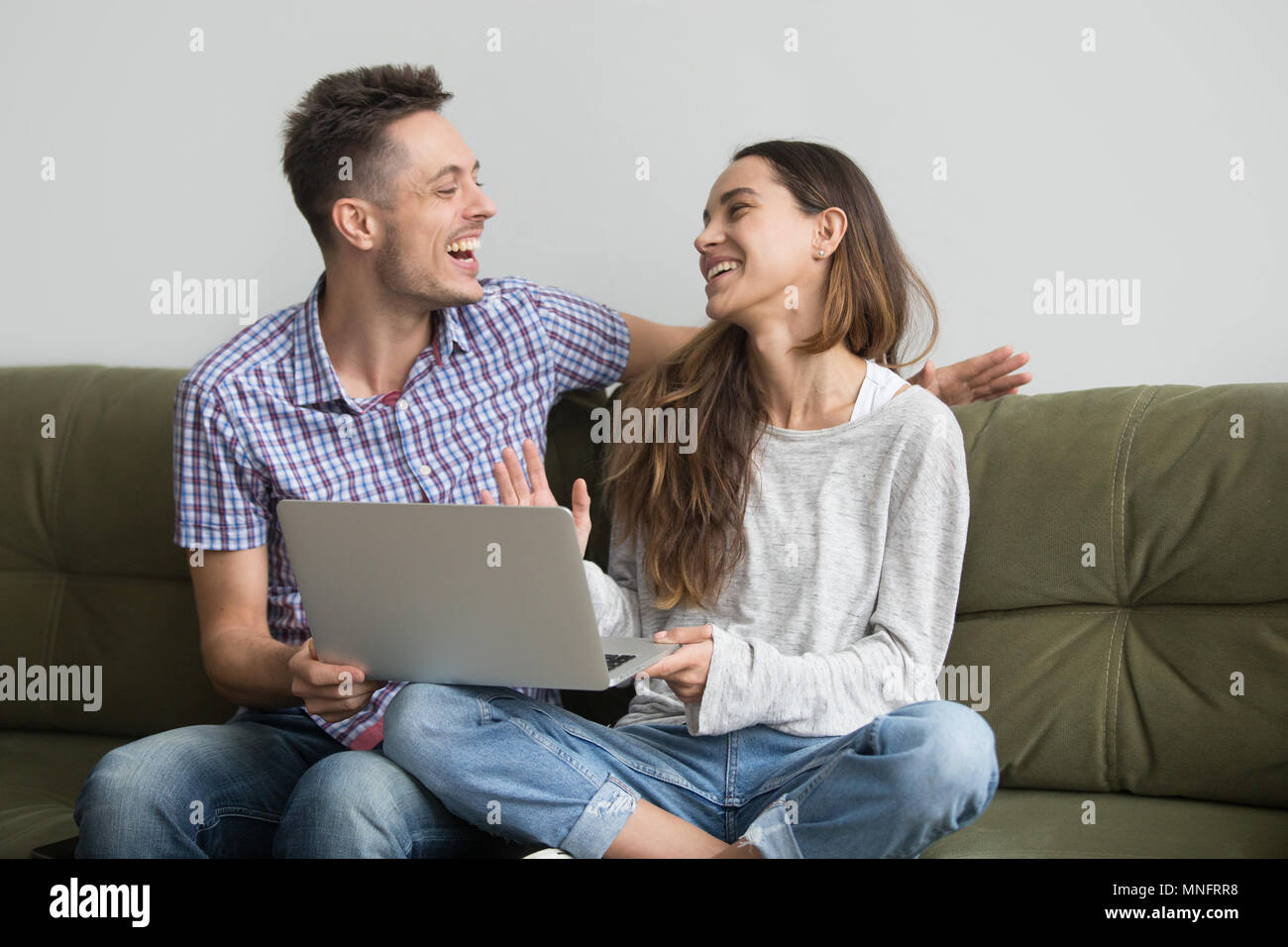 Couple laughing after watching funny video Stock Photo