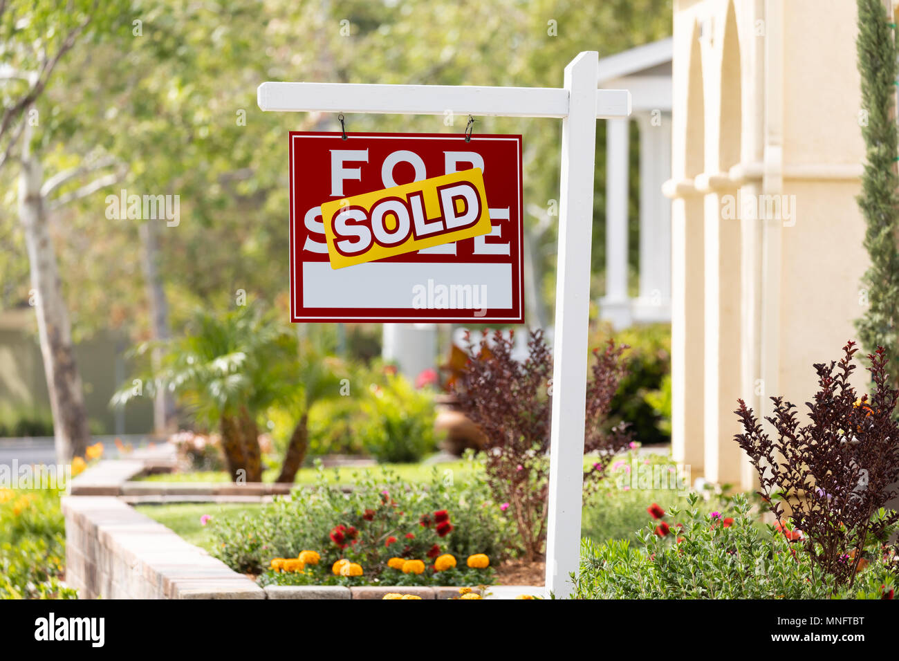 Sold Home For Sale Real Estate Sign in Front of New House. Stock Photo