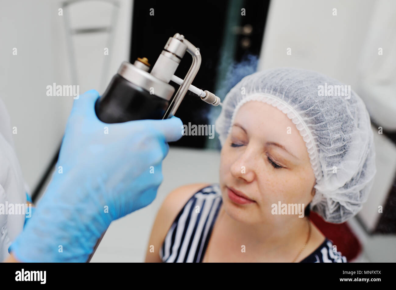 Doctor makes the patient Cryomassage Stock Photo