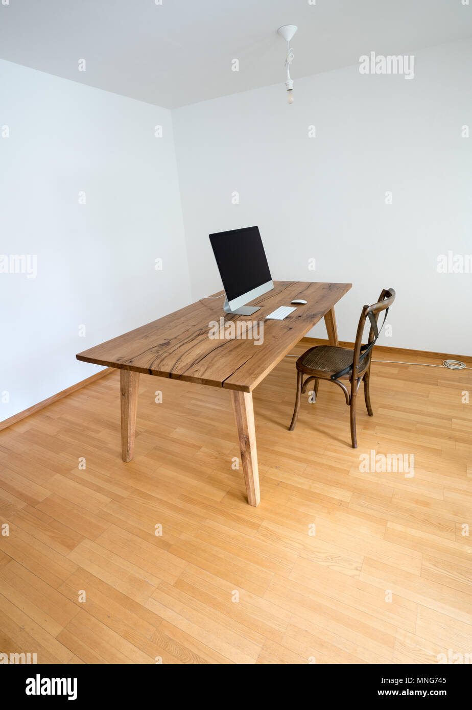 minimalist office with table and chair and computer Stock Photo - Alamy