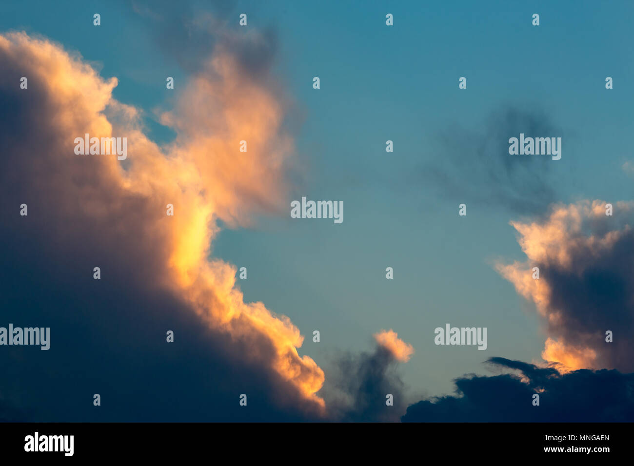 Colorful golden and blue dramatic sky with clouds at sunset Stock Photo ...