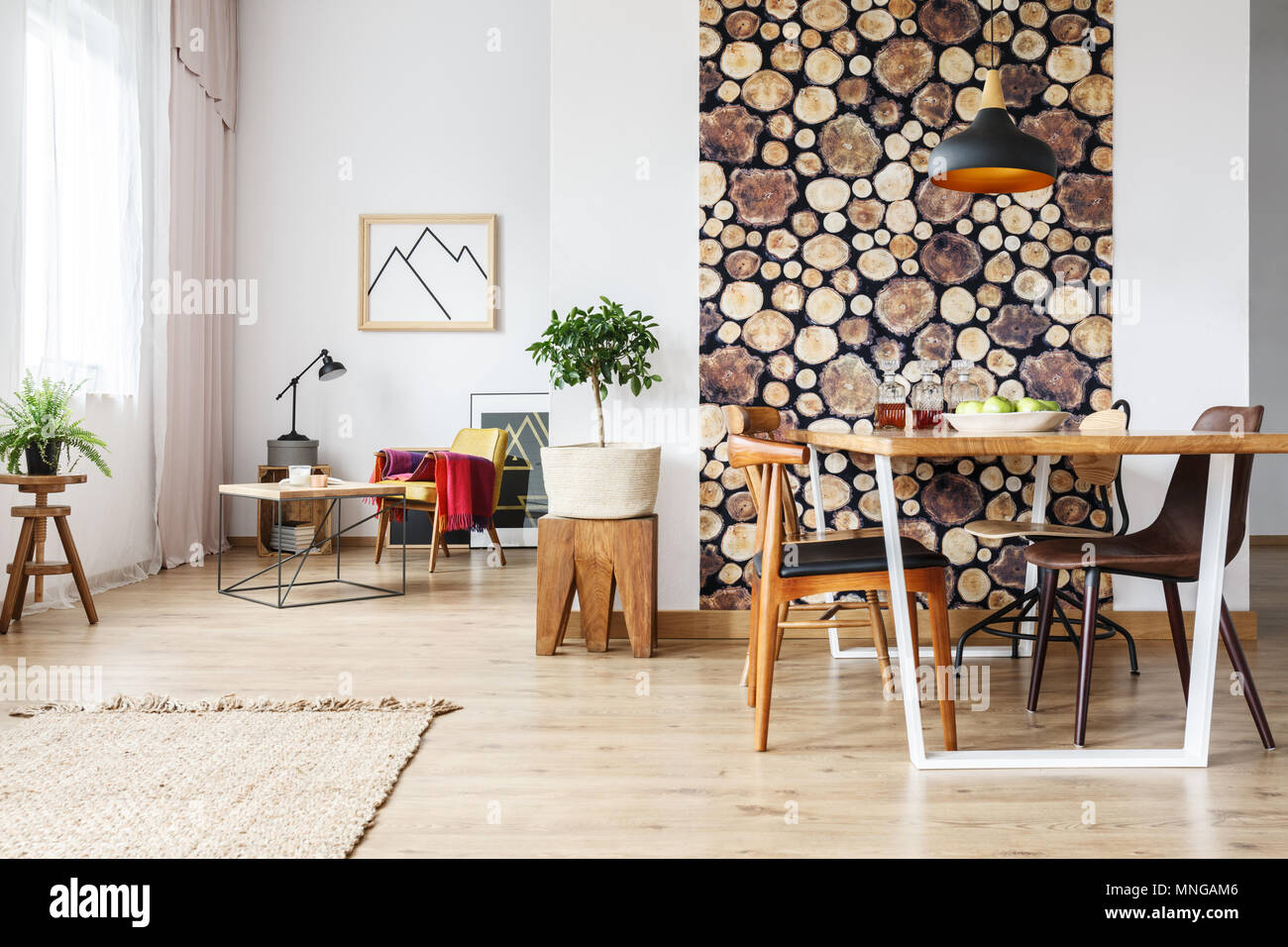 Dining table and rustic brown chairs in contemporary spacious flat with