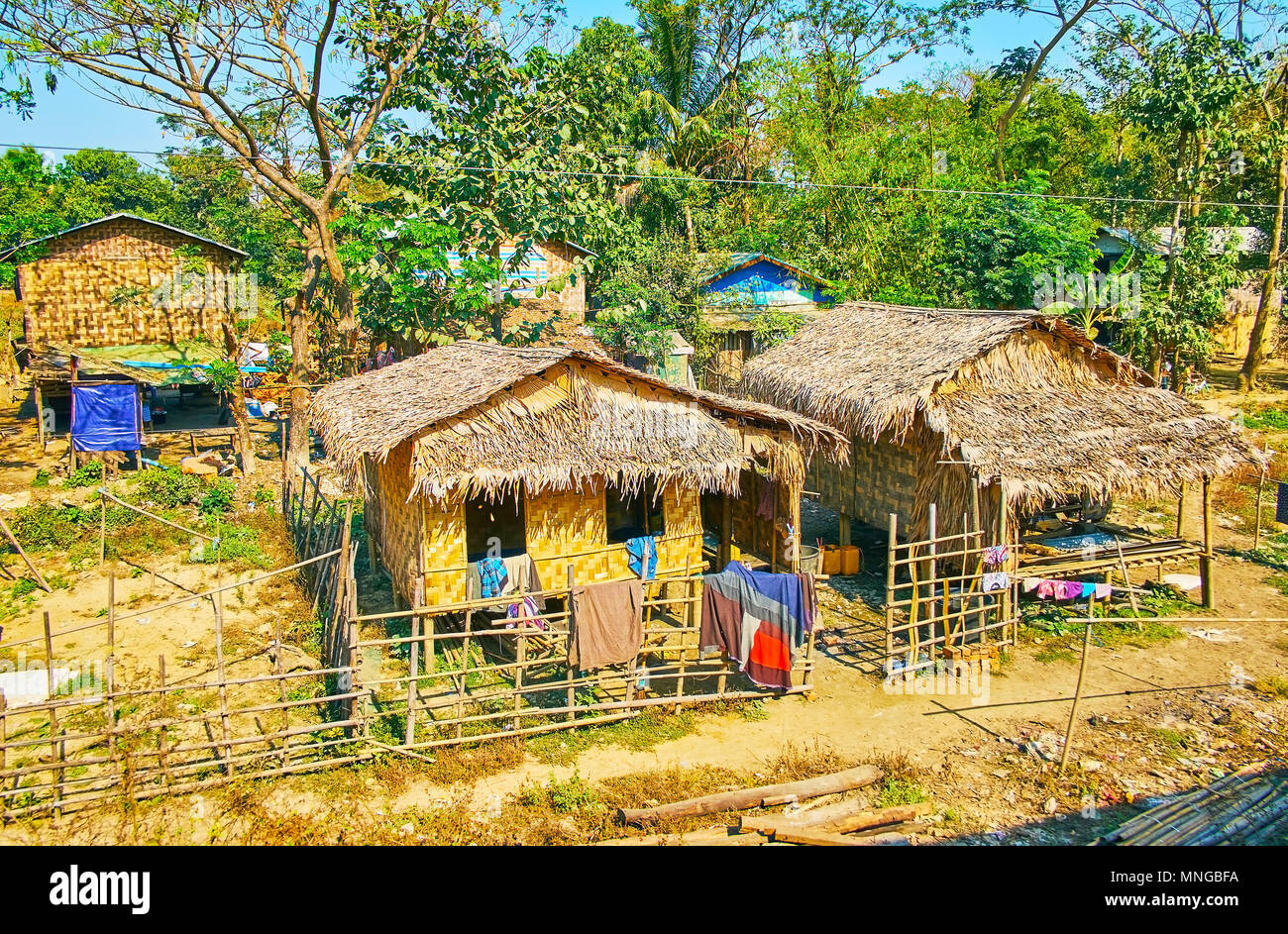 Traditional village stilt houses are made of woven bamboo and palm leaves, Bago Region, Myanmar. Stock Photo