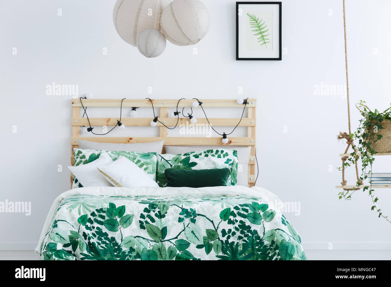 White Bedroom With Wooden Bed Swing And String Lights Stock