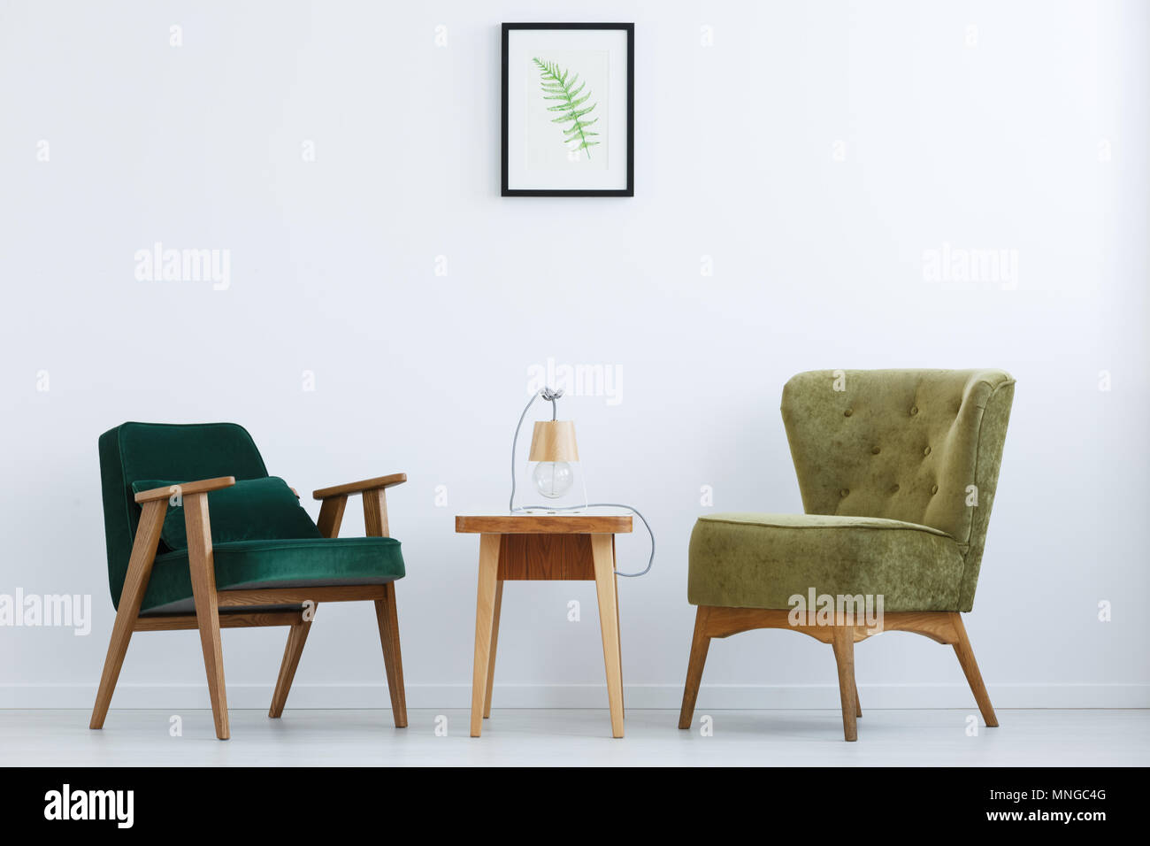 Ascetic, white home interior with green chairs, table and lamp Stock Photo
