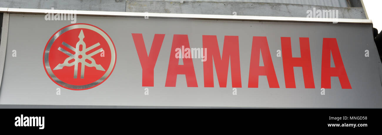Yamaha motorbike sign on wall with logo Stock Photo