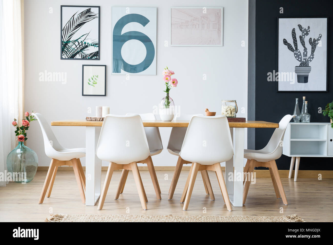 Bright spacious dining room with flowers and posters Stock Photo Alamy