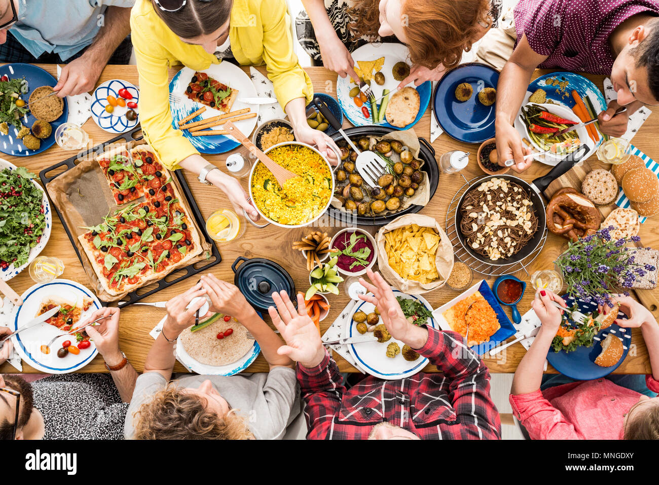 People talk and eat together during meeting at table with bio and