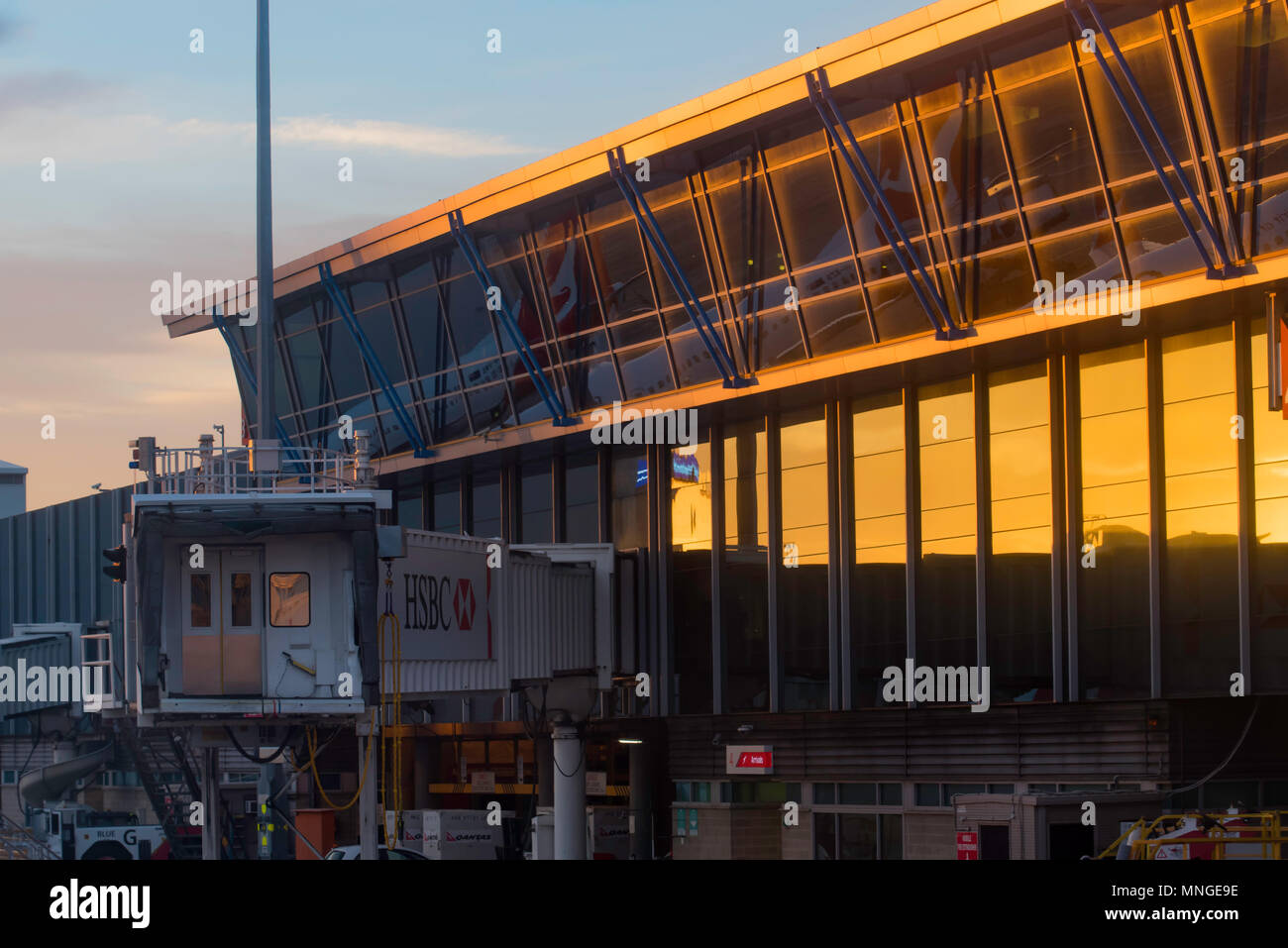 Departure lounge and air bridge at Sydney Airport looking from the tarmac, air side as the sun rises Stock Photo