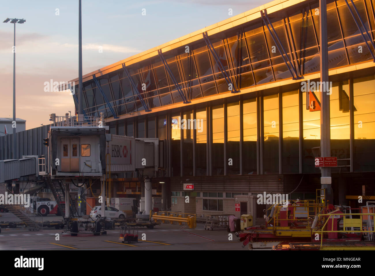 Departure lounge and air bridge at Sydney Airport looking from the tarmac, air side as the sun rises Stock Photo
