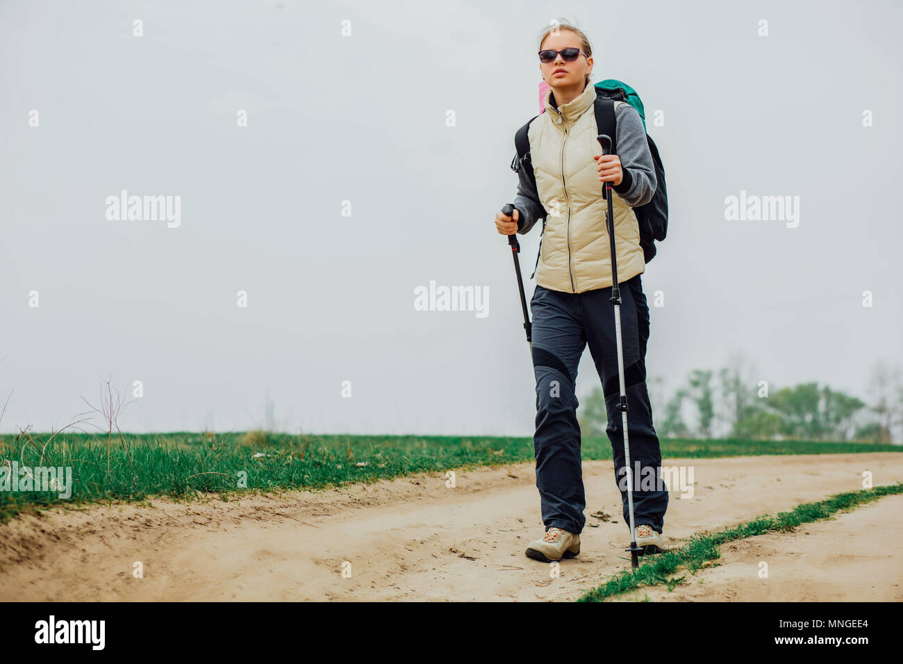 female hiker walking along a hiking trail, low viewing angle. Stock Photo