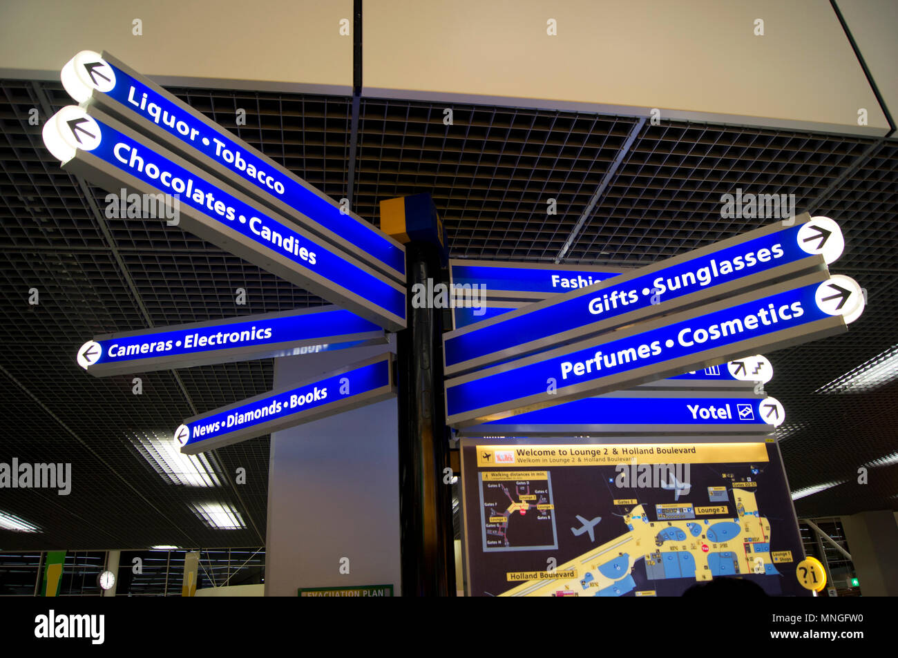 Signpost in the departure lounge at Schiphol International Airport in Amsterdam, The Netherlands, indicating the direction of shops. Stock Photo