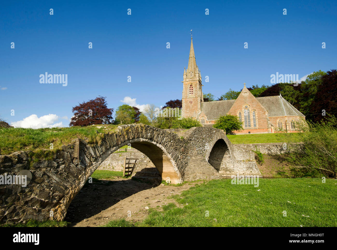 Subscription Bridge, Stow with St Mary of Wedale Church behind.  Also known as Packhorse bridge. Stock Photo