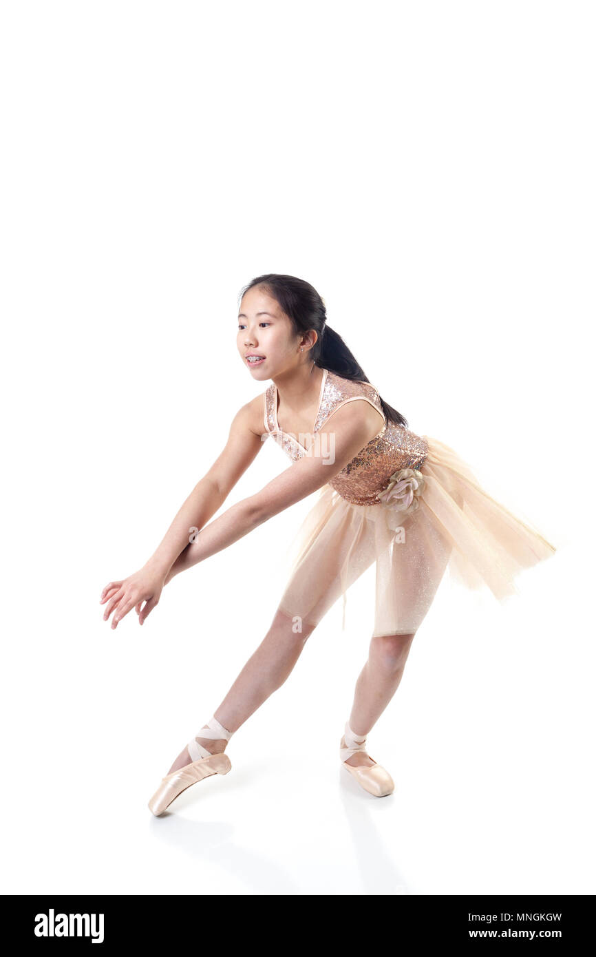Young Asian ballerina making a ballet pointe movement. Isolated on white background. Stock Photo
