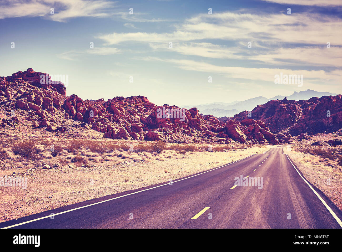 Retro toned desert road, travel concept, Valley of Fire; Nevada, USA. Stock Photo