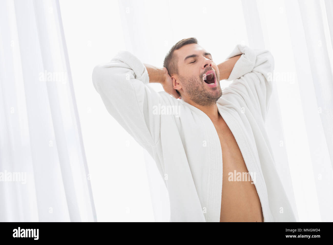 Nice handsome man yawning Stock Photo