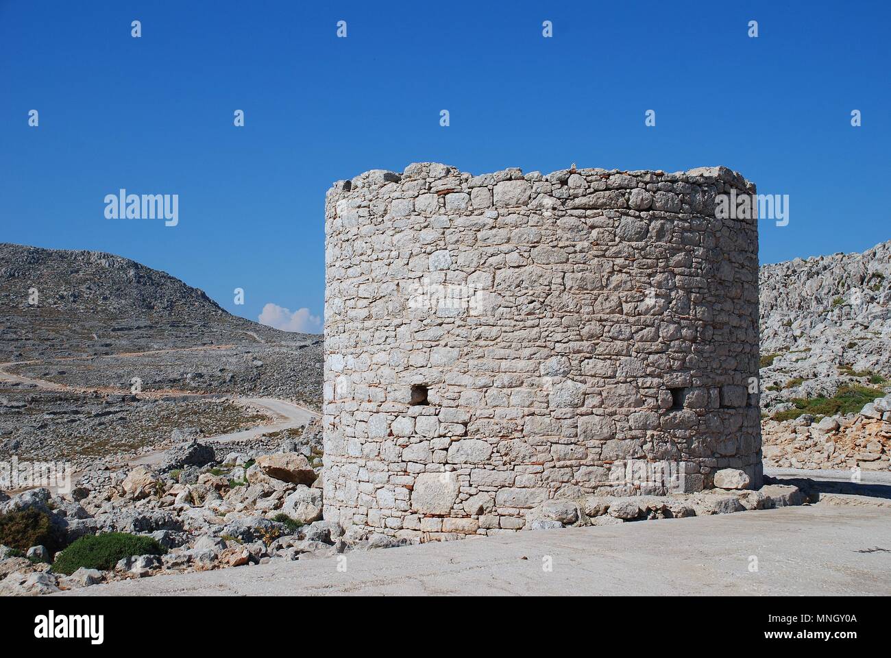 An old stone windmill on the high plateau of the Greek island of Halki on June 12, 2015. Stock Photo