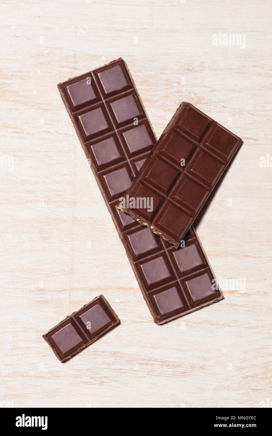 A lot of variety chocolates bar in box on white wooden background Stock Photo