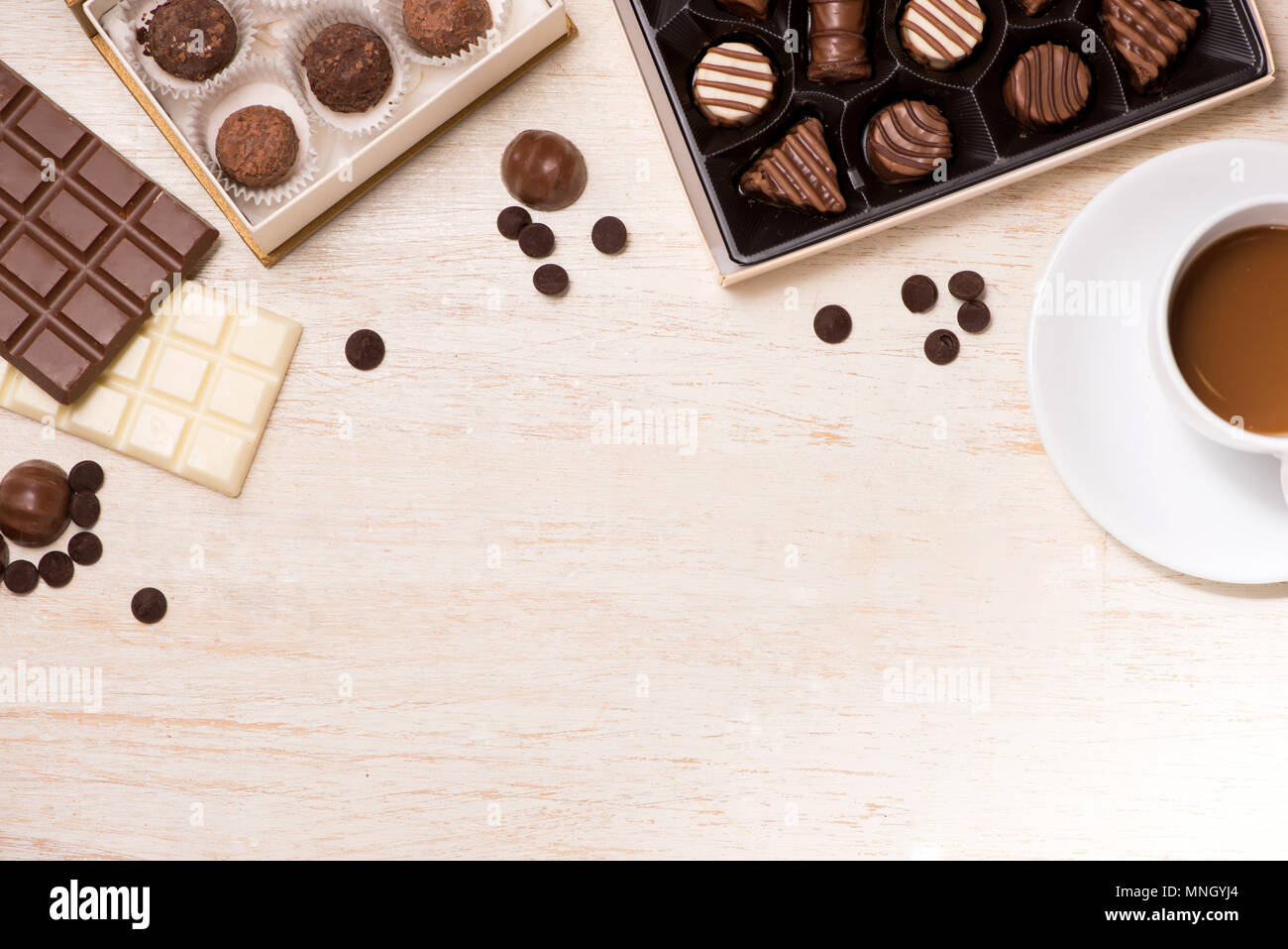 Glass of chocolate milk and variety chocolates  on table Stock Photo