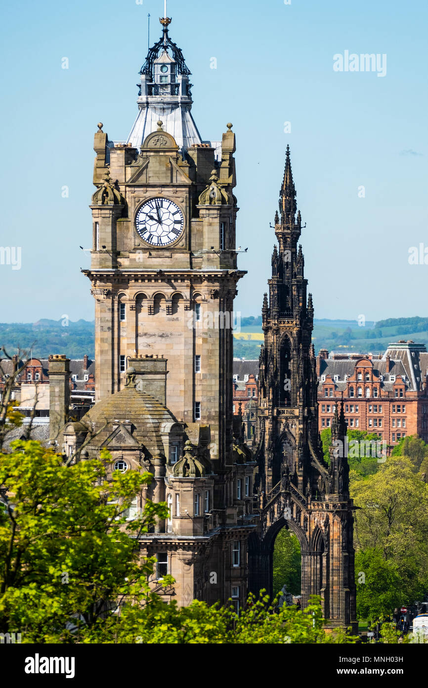 View of clocktower on Balmoral Hotel and Scott Monument on Princes Street in Edinburgh, Scotland, UK. Stock Photo