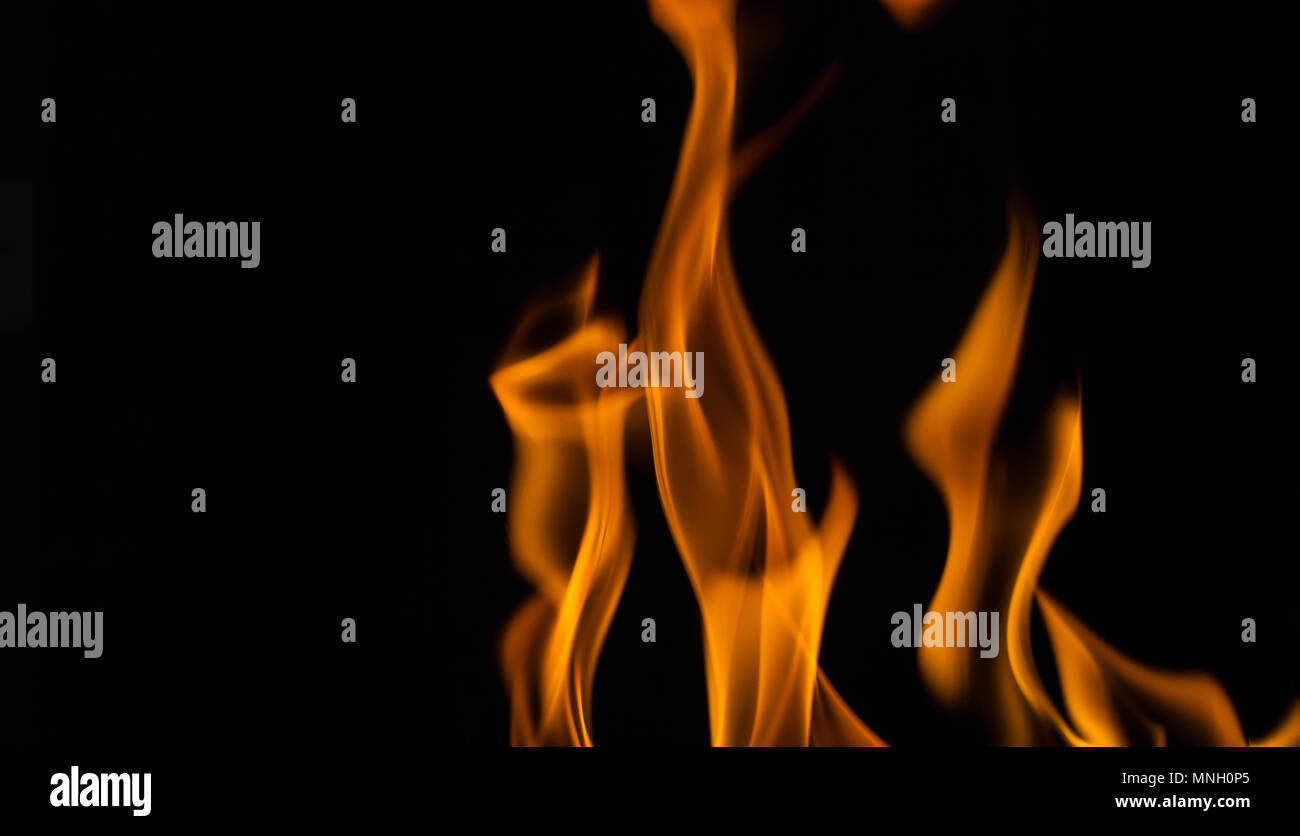 Beautiful yellow fire flames on black Stock Photo - Alamy