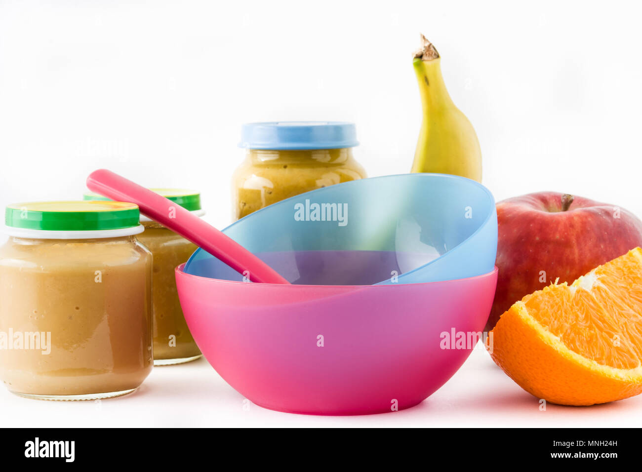 Baby food Jar with fruit puree and colorful bowls isolated on white background Stock Photo Alamy