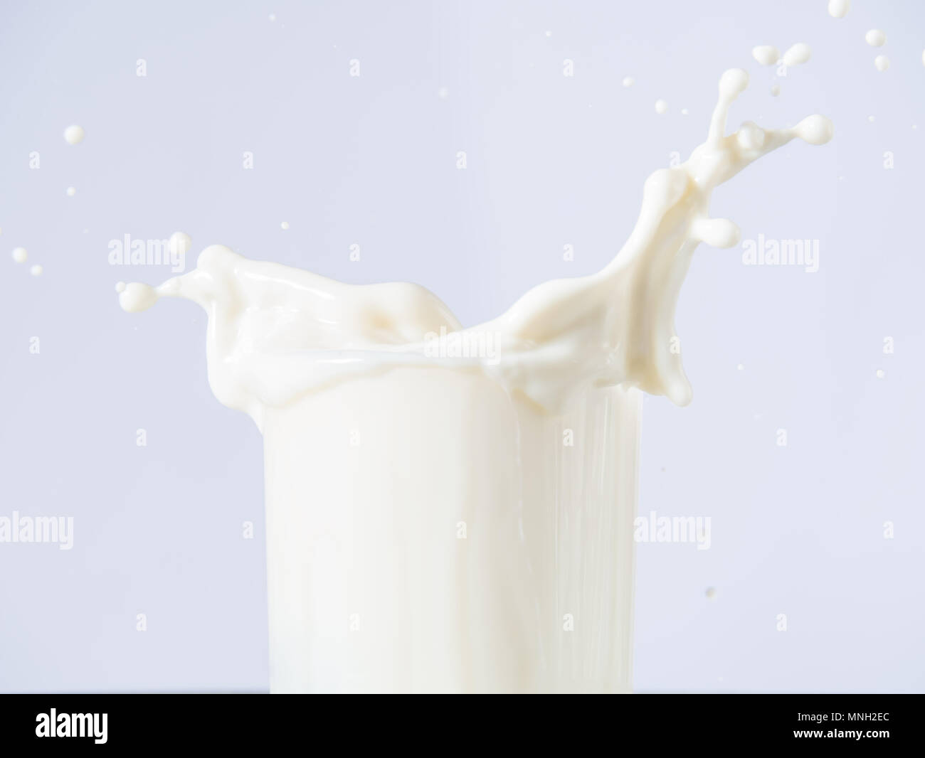 Milk splash on white background Stock Photo - Alamy