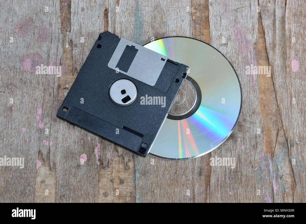 floppy disk and compact disc on wood board Stock Photo