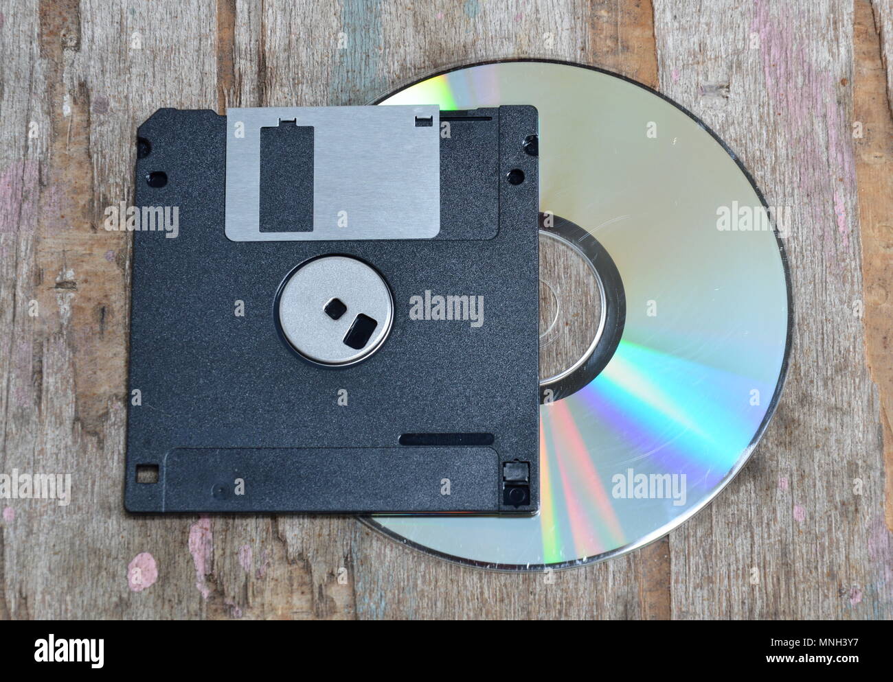 floppy disk and compact disc on wood board Stock Photo