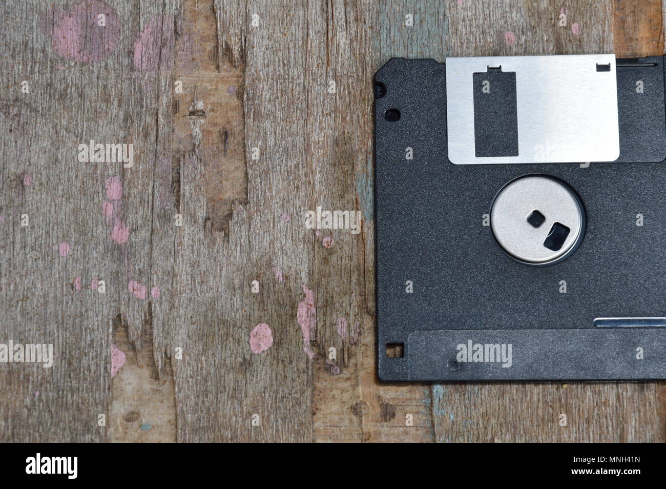 black floppy disk on wood board Stock Photo