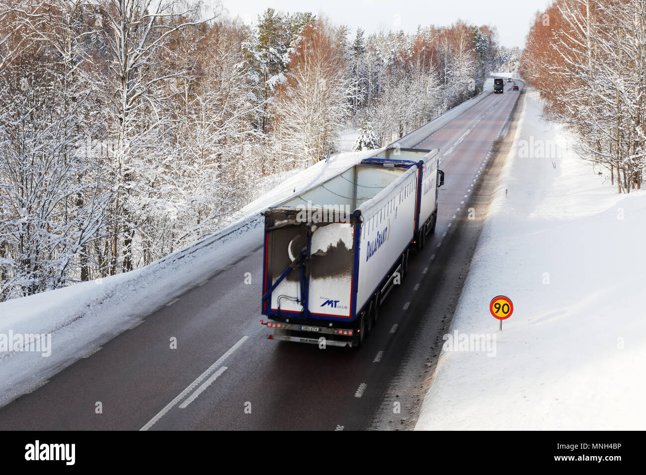 Gagnef, Sweden - February 9, 2018: Truck on national road 70 surronded by snow and speed limited to 90 kmh. Stock Photo