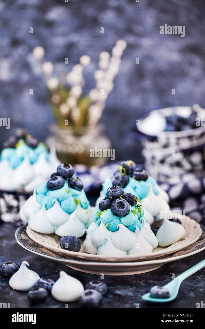 Delicious blueberry Pavlova meringue cakes decorated with cream and