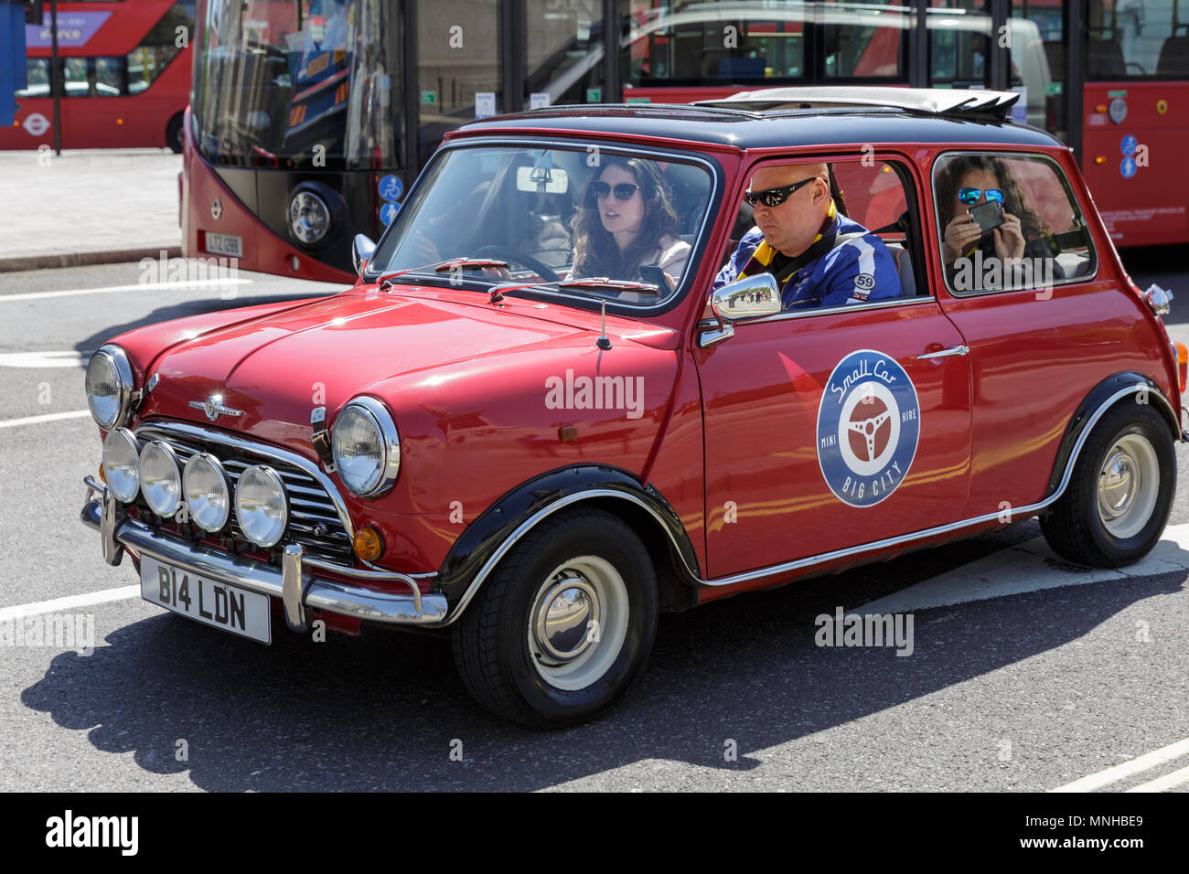 London, 17th May 2018. A red Mini gleams in the sunshine on Trafalgar Square.Around London, tourists and Londoners enjoy a beautifully sunny and warm day in the capital. Credit: Imageplotter News and Sports/Alamy Live News Stock Photo