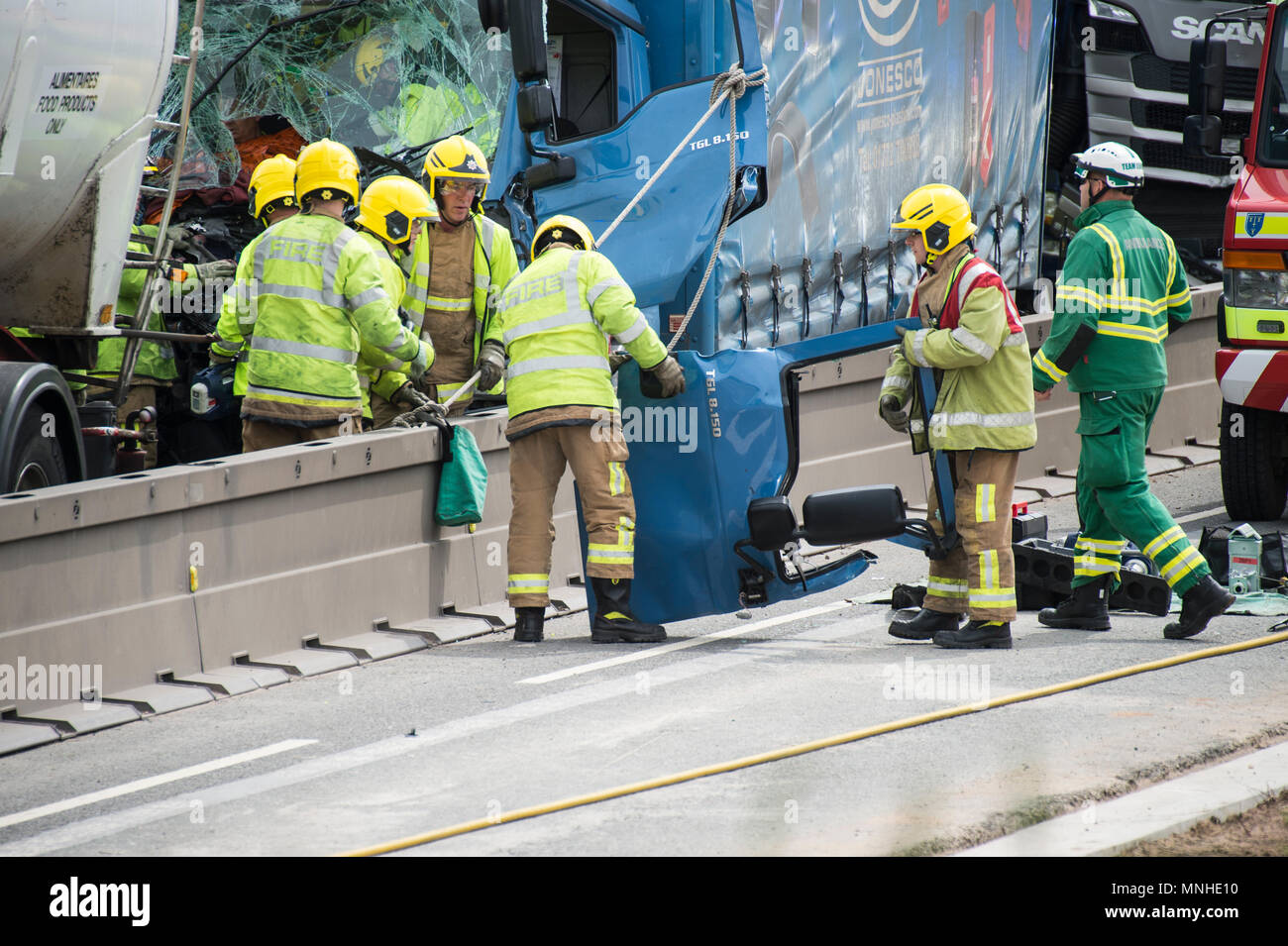 M6, between Holmes Chapel and Knutsford, Cheshire, UK. 17th May, 2018. Four HGVs crash one man trapped fire service and ambulance crews trying to extracate him air ambulance Credit: Chris Billington/Alamy Live News Stock Photo