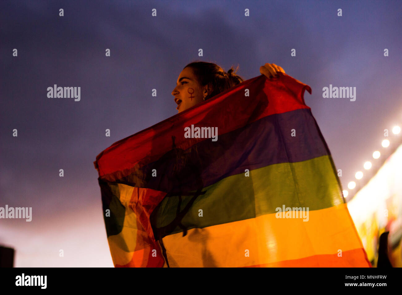 Feminist march / demonstration from march the 8/4/2018. Manifestación feminista del 8 de marzo de 2018. An LGBT activist holds a pride flag. Stock Photo