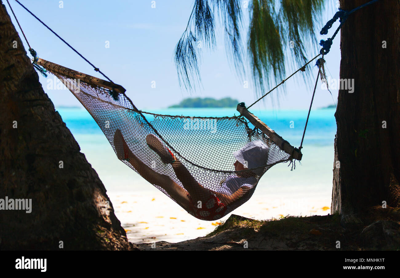 Adorable little girl swinging in hammock at beach Stock Photo Alamy