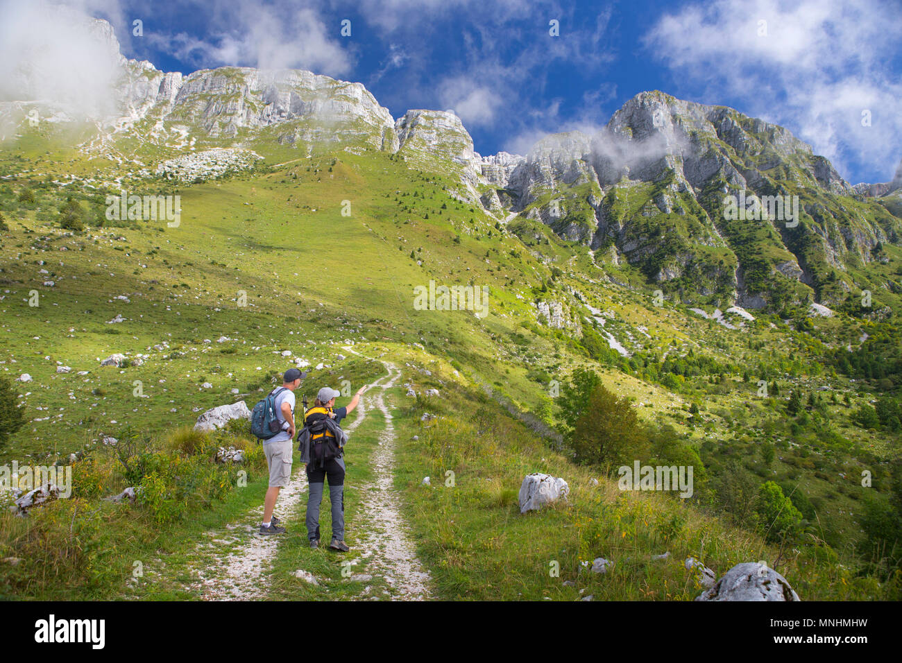 Two hikers on their way to Krn mountain in Julian Alps, Triglav, Slovenia Stock Photo